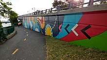 A mural by Silvia López Chavez along the Paul Dudley White bike path on the Charles River Esplanade.