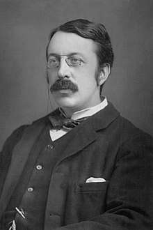 head and shoulders of a young man with moustache and pince-nez