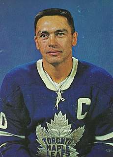 Armstrong poses for a studio shot in his Maple Leafs uniform.  His sweater features a "C" patch denoting he was captain of his team.