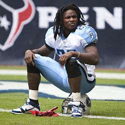Chris Johnson sitting on his guard helmet at a American football game in 2010