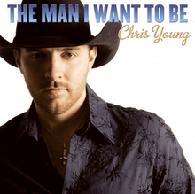 The cover has the artist set against a white background, wearing a black cowboy hat, dark blue dress shirt and a gold cross necklace. The song title appears above the artist, boldly written in blue, and the artist's name is set below the song title to the right of the cover, cursively written in gold.