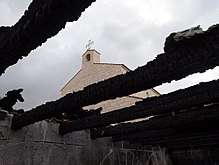 Photo showing the Church of the Multiplication after an arson attack on the adjacent library building.