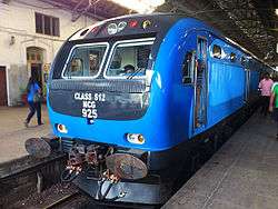 Blue locomotive in a station