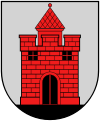 A coat of arms depicting a red castle with black double doors, two black windows, and one central tower all standing on black ground
