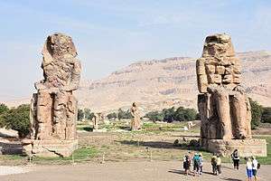 Two huge statues of seated figures