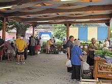 People shopping in an open-air farmers' market