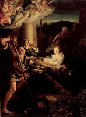 Nativity scene with angels and cherubs in the upper left-hand corner. Light is emanating from the center of the picture, where the Christ child is positioned, creating shadows and light all around the central group of Mary and the shepherds. Joseph and some animals are in the background.