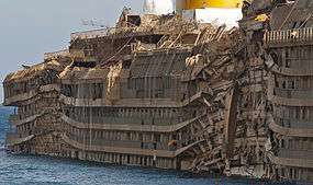 Starboard side of the righted Costa Concordia, showing the crushing impact of the rock spurs upon which it rested.