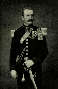 Portrait photograph of a young man wearing a military uniform with a prominent moustache