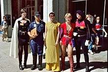 Photograph of five people standing together in costume