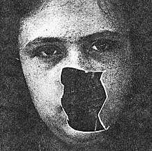 A charcoal drawing of a girl's face with a piece comprising her mouth and nose missing