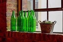 Green bottles on a windowsill