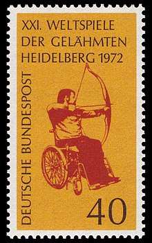 A postage stamp featuring a red image of an archer with drawn bow sat in a wheelchair, on a yellow background
