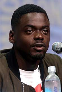 A photograph of Daniel Kaluuya speaking at the San Diego Comic-Con International in 2017