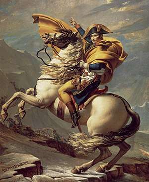 Napoleon on a rearing white horse pointing his men to continue their advance through a mountain pass.