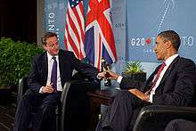 US President Barack Obama and British Prime Minister David Cameron trade bottles of beer to settle a bet they made on the U.S. vs. England World Cup Soccer game (which ended in a tie), during a bilateral meeting at the G20 Summit in Toronto, Canada, Saturday, 26 June 2010