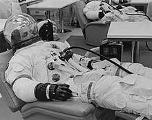 A man in a space suit, resting