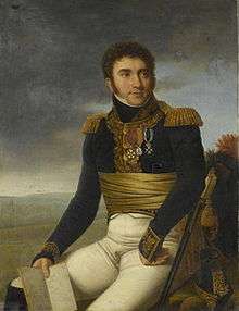 Painting depicts a curly-haired man, sitting with his right hand holding a map and left hand resting awkwardly on his leg. He wears a dark blue military coat with epaulettes and white breeches.
