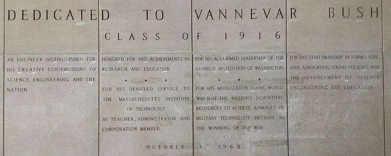 Four large panels with words carved in stone. The inscriptions reads: "Dedicated to Vannevar Bush Class of 1916. An engineer distinguished for his creative contributions to science, engineering and the nation. Honored for his achievements in research and education. For his devoted service to the Massachusetts Institute of Technology as teacher, administrator and corporation member. For his acclaimed leadership of the Carnegie Institute of Washington. For his mobilization during World War II of the nation's scientific resources to achieve advances in military technology decisive in the winning of the war. For his statesmanship in formulating and advocating sound policies for the advancement of science, engineering and education. 1&nbsp;October 1965"