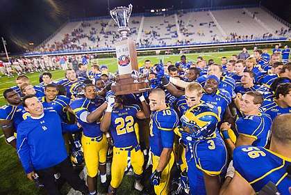 Delaware players Paul Worrilow (10), Leon Jackson (22) and Mark Schenaur (6) holds up the first state cup trophy after defeating Delaware State 45–0 Saturday Sept. 17, 2011, in Newark DE. Photo By Saquan Stimpson