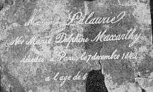 Black and white image of copper plate, bearing text reading "Madame Lalaurie, née Marie Delphine Macarty, décédée à Paris, le 7 Décembre, 1842, à l'âge de 6--."