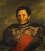 Painting of a smiling clean-shaven man with long sideburns. He wears a red military uniform with a fur-lined cloak thrown over his shoulders.