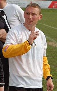 Player-Manager in a White, Carmarthen Town, T-shirt.