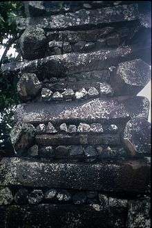 Image of columnar basalt pieces, 3 to 6-sided, stacked in alternating directions to build a thick wall at Nan Madol, Pohnpei, Micronesia