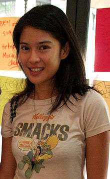 A colour photograph of a young woman in a T-shirt looking forward.