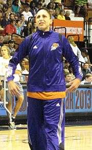Young woman wearing a purple shiny warmup suit