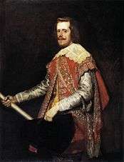 Portrait of the king of Spain, who has a long pale face and a curling moustache. He wears a scarlet coat richly embroidered in gold, and has a large collar trimmed with lace. He carries a black broad-brimmed hat. He stands as if he has just stopped for a moment.