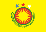 On a yellow field, A coat of arms with a yellow sun on top of a red circle with a green border, with green branches below it, and blue, red, and white stars above it.