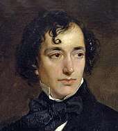 A young man of vaguely Semitic appearance, with long and curly black hair