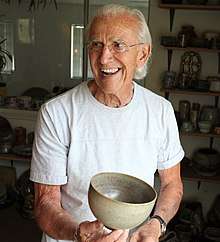 Don Reitz holding a ceramic bowl