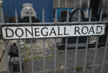 "Donegall Road" street sign attached to metal railings.