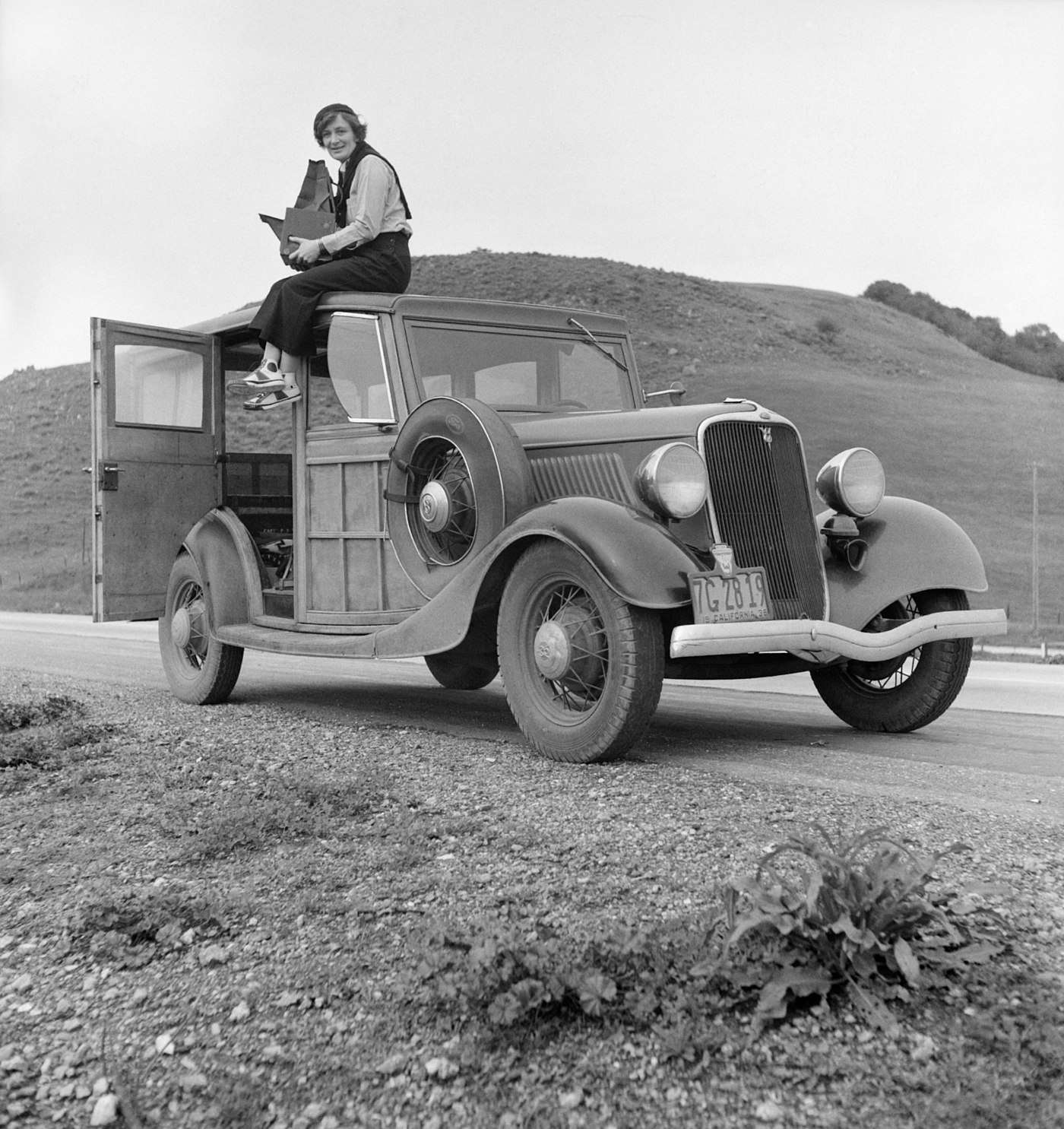Dorothea Lange atop automobile in California (restored).jpg