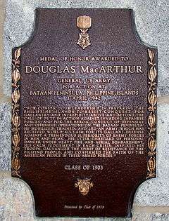 A bronze plaque with an image of the Medal of Honor, inscribed with MacArthur's Medal of Honor citation.