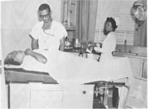 Dr. Moore, Obstetrician-Gynecologist, examining a patient, undated.