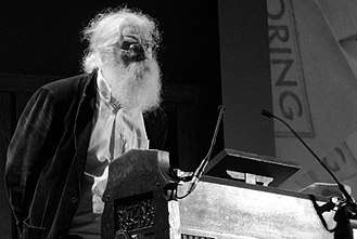 Photograph of Irving Finkel standing behind a lectern