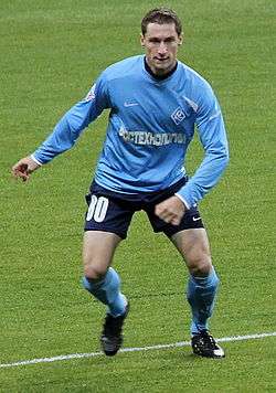 A white footballer in his early twenties, wearing a Krylia Sovetov light blue kit, on a football pitch during a match.