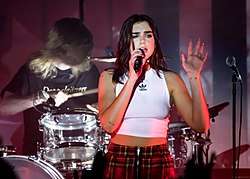 Colour picture of Dua Lipa performing during her tour