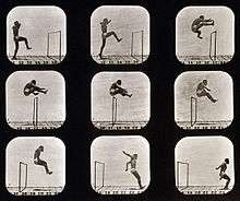 Nine photographs, arranged in 3 rows of 3, show the sequence of a man's jump over a hurdle. The first photo at the top left shows the man in front of hurdle with his right leg raised.  As he propels himself over the hurdle, he pulls his trailing left leg up and in front of him while pushing his arms to the back.  The last three photos show him as he clears the hurdle and lands on both feet.