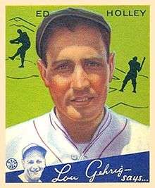 A baseball card image of a man in a white baseball uniform with red trim and a black newsboy hat