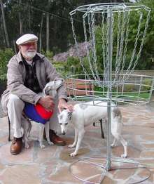 Ed Headrick with his two whippets with a new DGA disc golf lightweight all metal disc golf target. Photo taken in 2002 two months before he passed away.