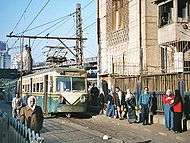 Older tram at a station
