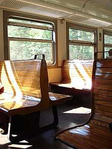 Inside of old train, with wooden seats