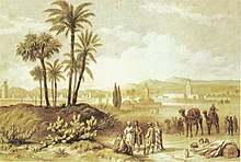 A landscape painting featuring some palm trees with a city in the background, with a group of people and camels by the trees