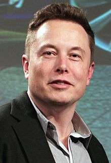 A close-up of Musk's face while giving a speech