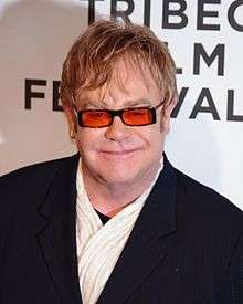 Elton John, with tinted glasses