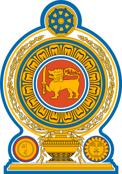 Coat of arms of Sri Lanka, showing a lion holding a sword in its right forepaw surrounded by a ring made from blue lotus petals which is placed on top of a grain vase sprouting rice grains to encircle it. A Dharmacakra is on the top while a sun and moon are at the bottom on each side of the vase.